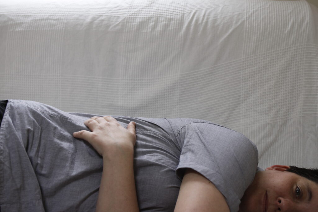 alt="woman lying on bed"