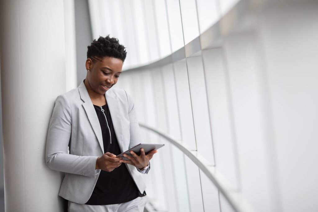 woman standing while holding tablet