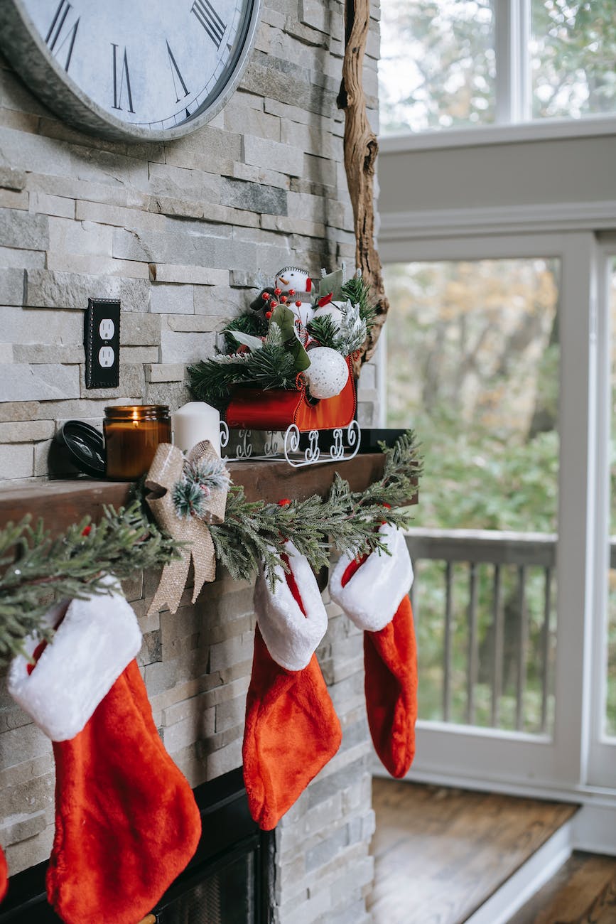 xmas decorations on brick wall above fireplace