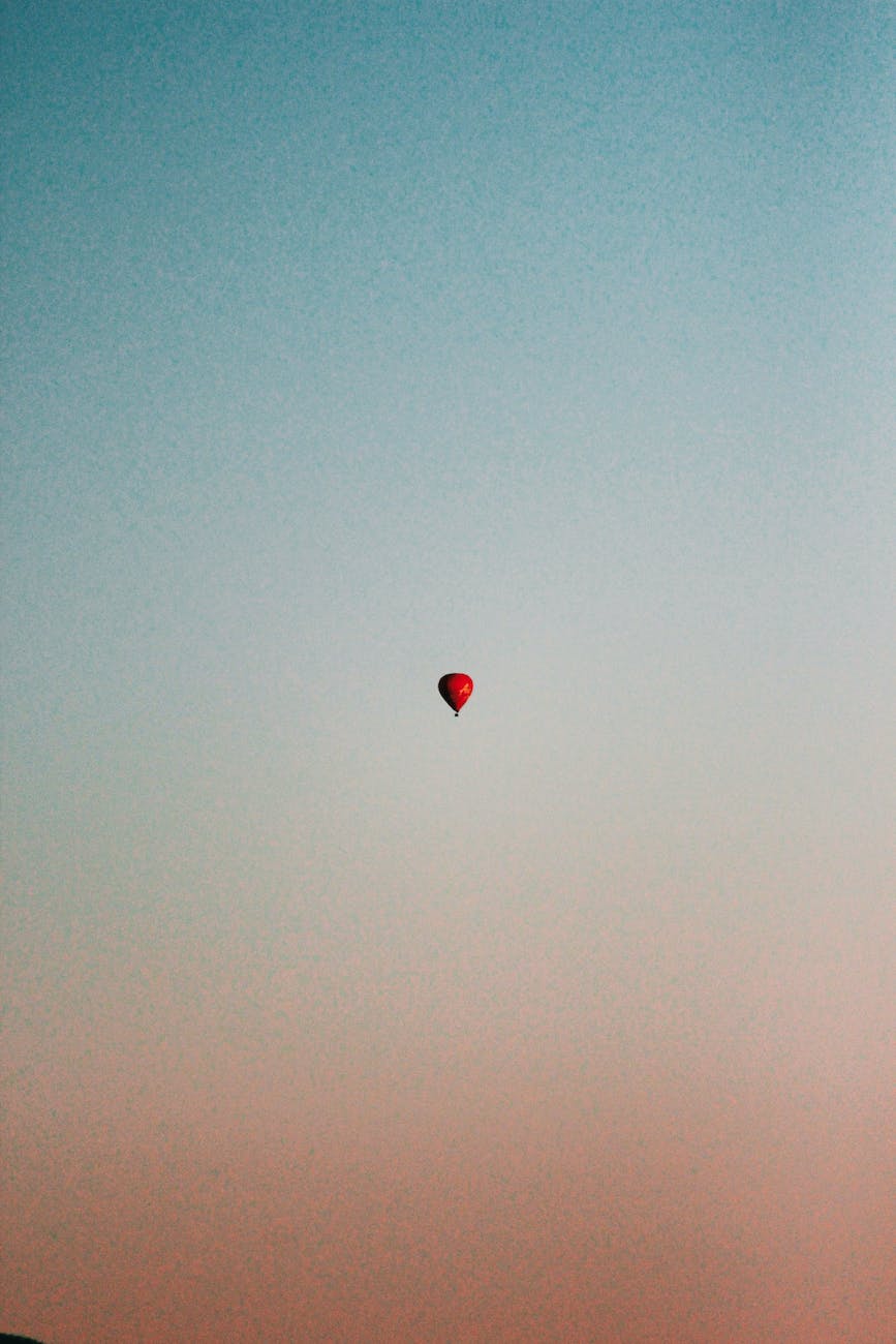 red hot air balloon on sky
