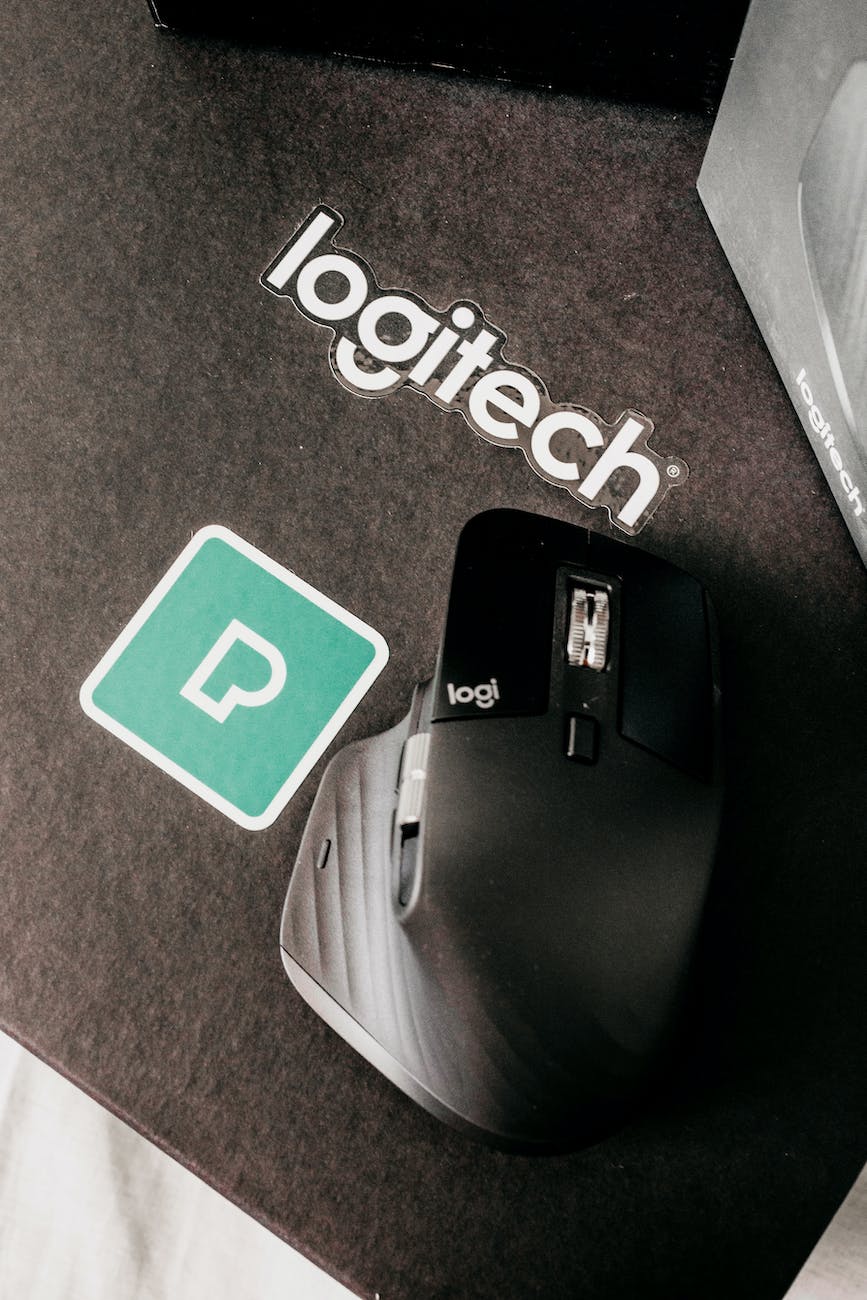 modern mouse in holder on mat with inscription