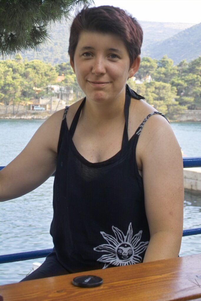 Woman sitting by the water