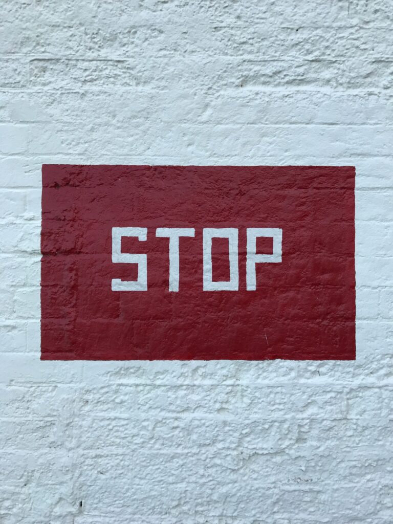 Stop painted on a white wall