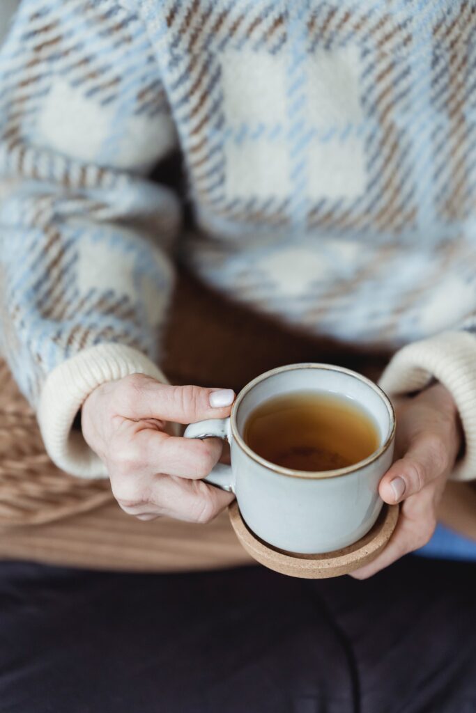 Person holding a cup of tea