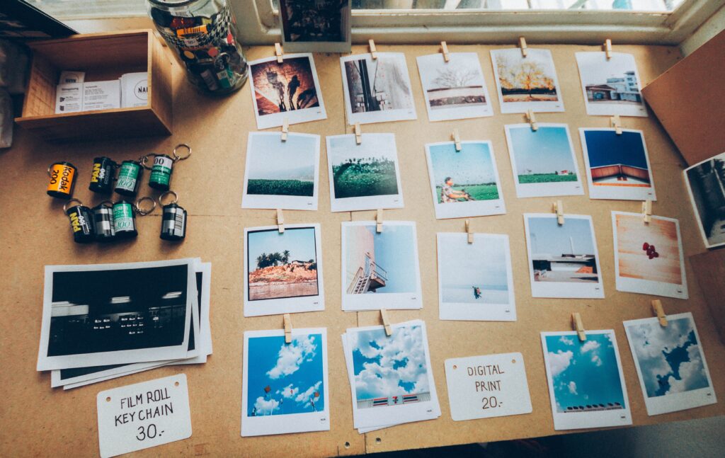 Row of Polaroid prints laid out on a table.