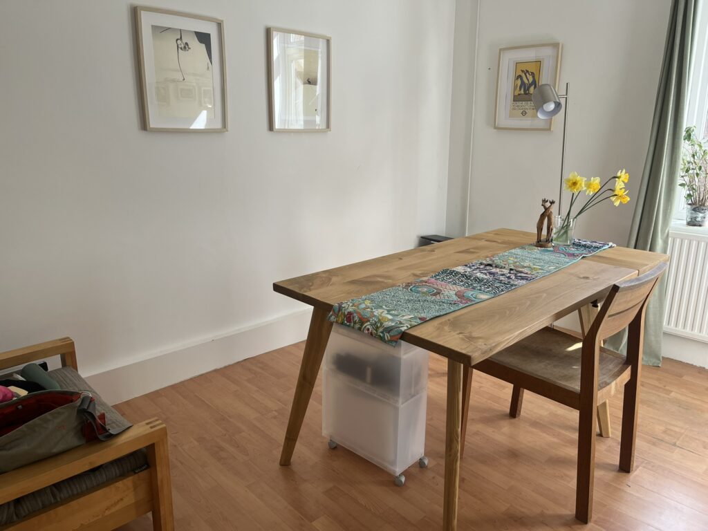 New dining table with coloured table cloth and flowers. 