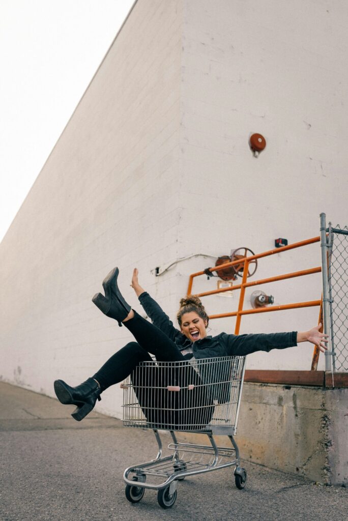 Woman sitting inside a shopping trolley