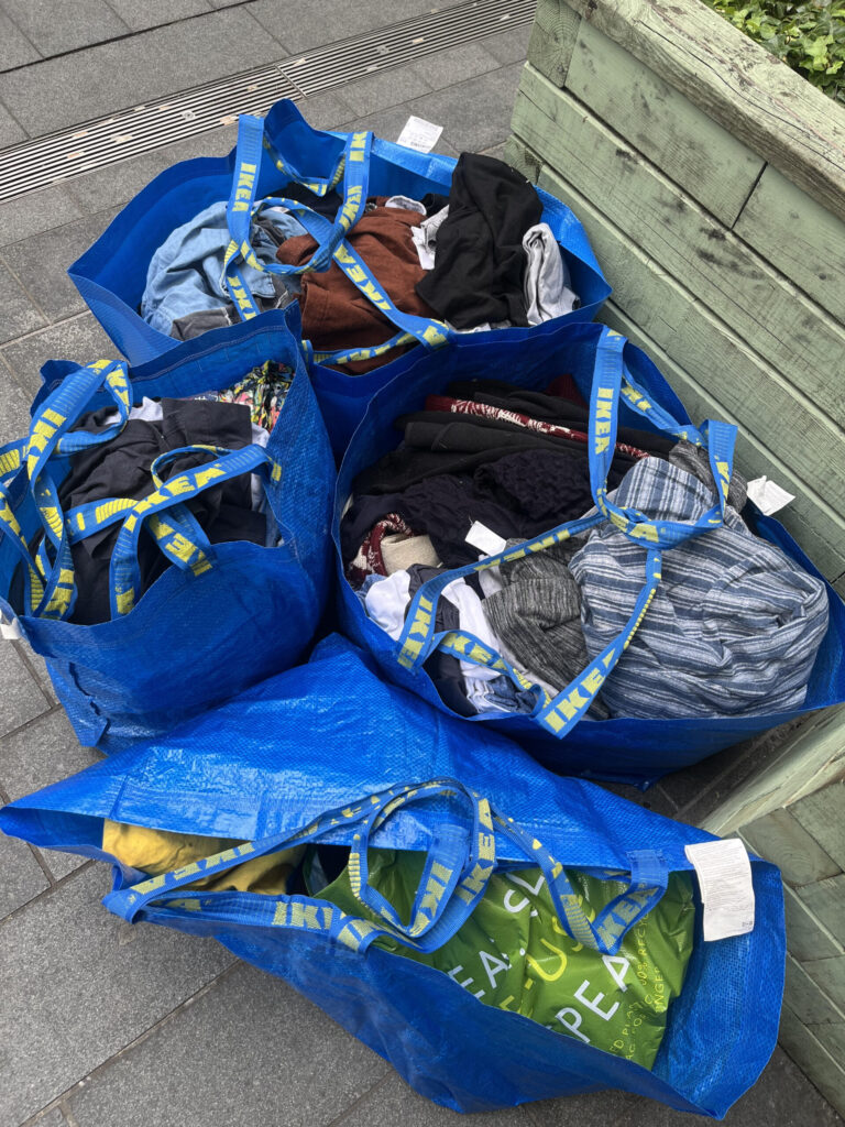 Blue Ikea bags with donations for the charity shop