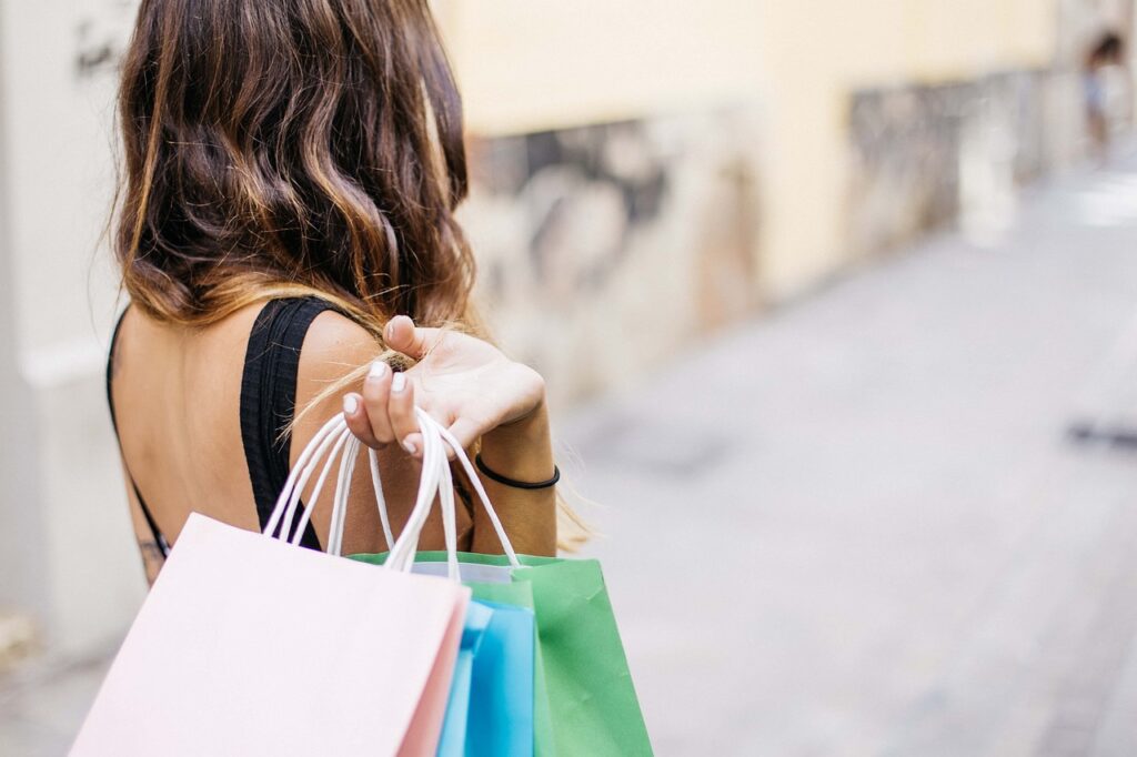 Women seen from behind holding shopping bags