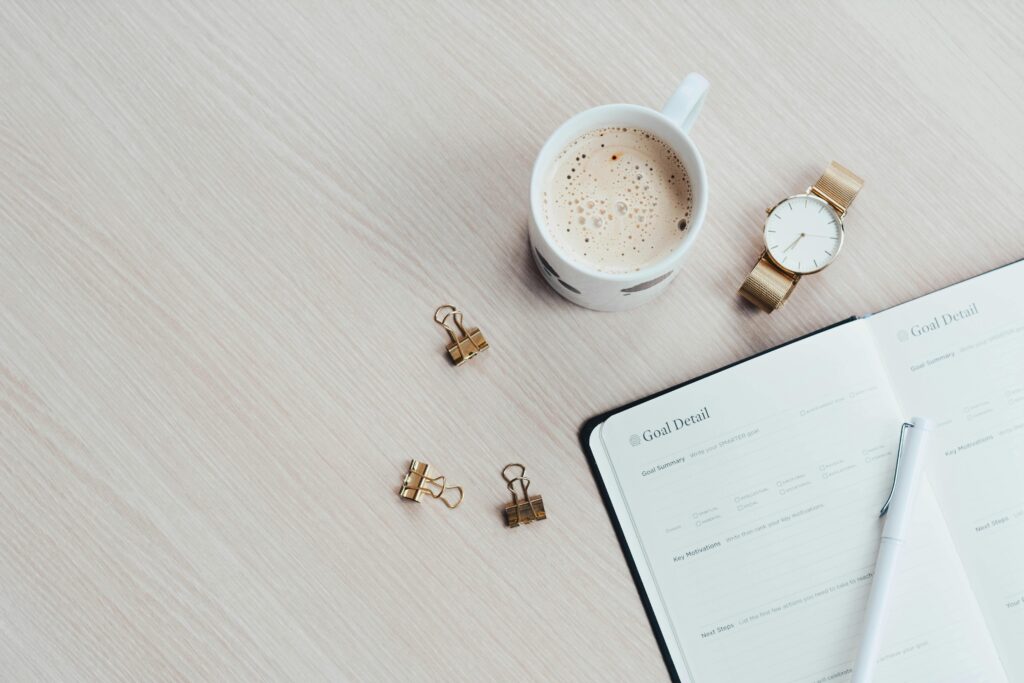 Paper Planer on table with pen, mug and watch