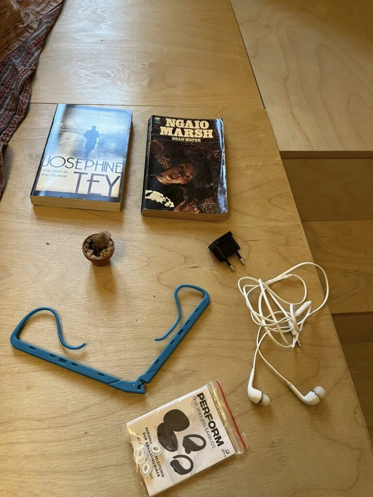 2 books, flower, headphones, plug, bookholder