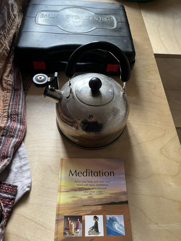 Meditation book, kettle and camping stove