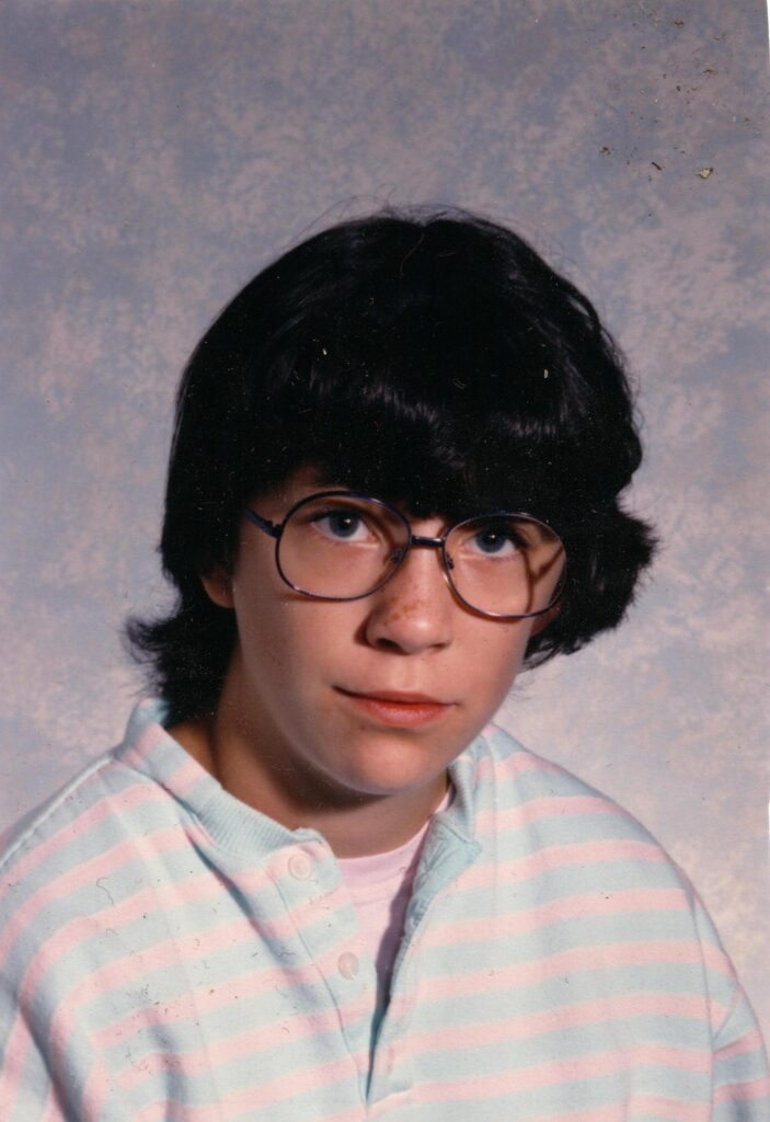 Me with Geeky, purple 80s glasses.