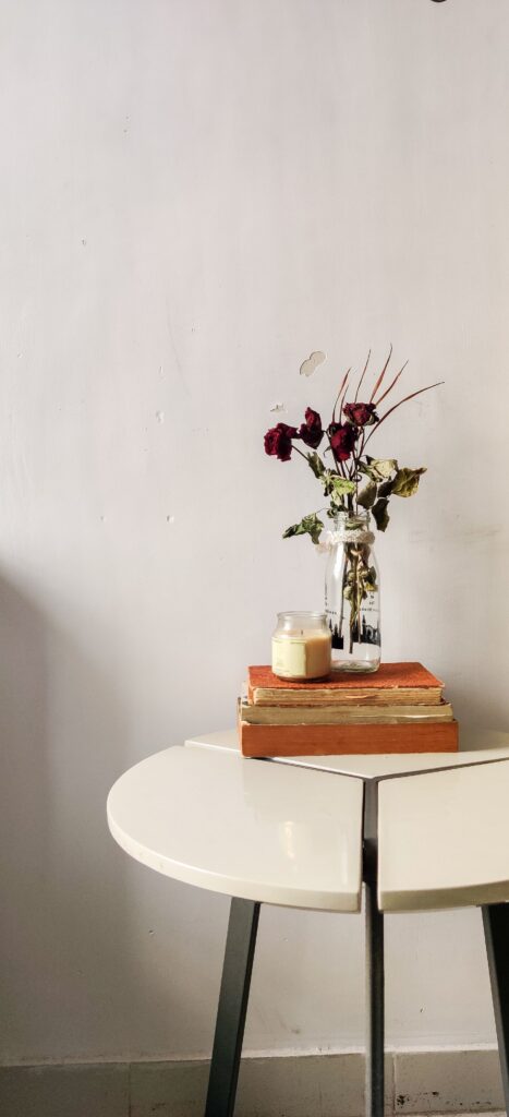 Table with flowers, cancle and three old books