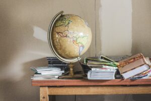 Table with globe and piles of books