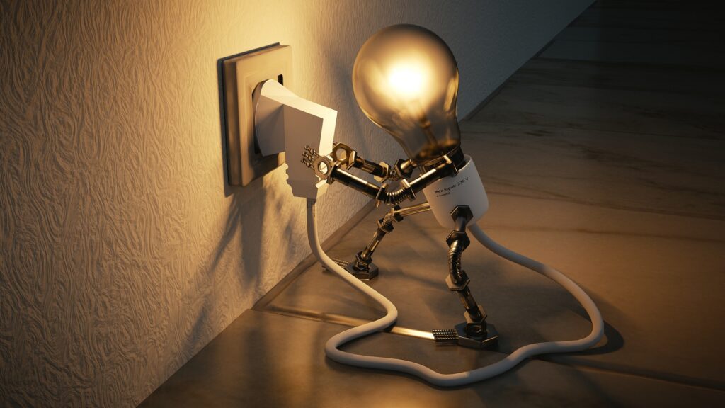Lightbulb figure plugged into the wall